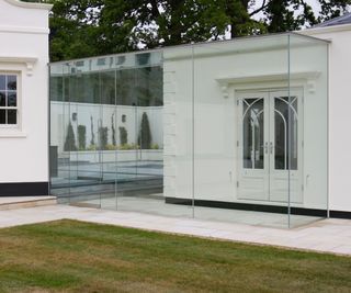 seamless glazed link walkway between two white properties