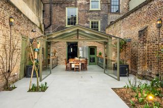 glass extension to brick building with modern kitchen