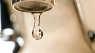 A water droplet coming from a tap